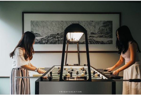 2 ladies play on a Tornato T3000 foosball table